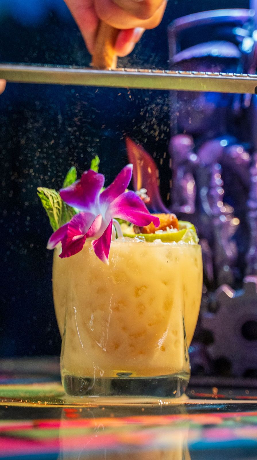 A Mai Tai with an orchid under blacklight at Endless Bummer